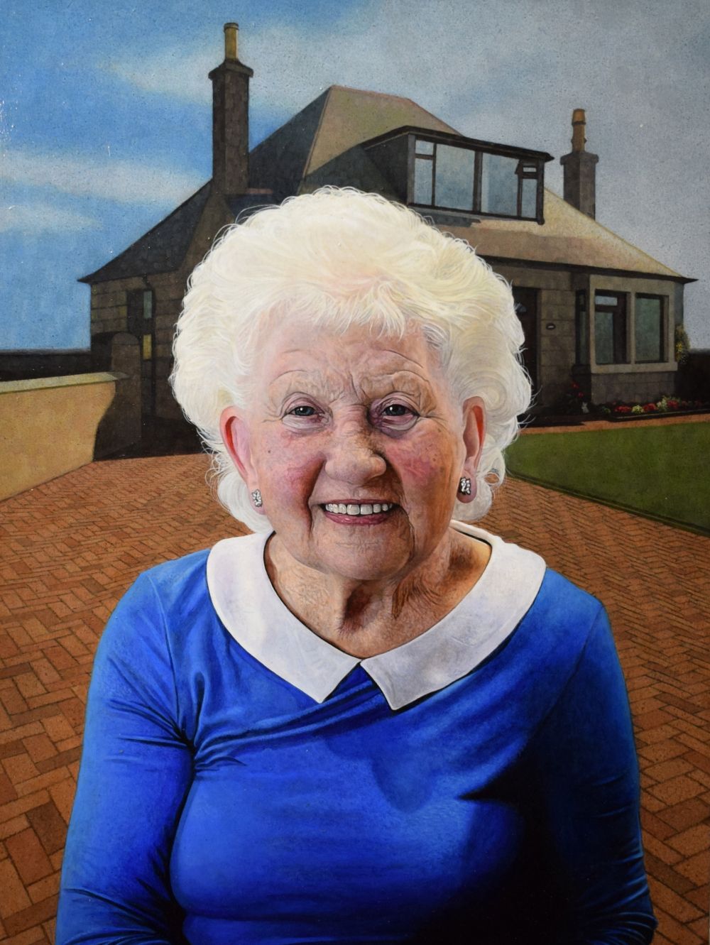 Elderly woman smiling in front of her home